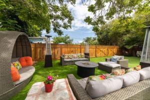 a backyard with wicker couches and a table at Casa Sur in Chula Vista
