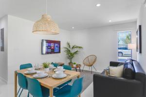 uma sala de jantar com uma mesa e cadeiras azuis em Stunning 3-Bedroom Duplex with Free Parking em Miami