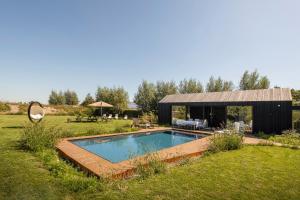 a swimming pool in the yard of a house at Ter Heyde Walle in Koekelare