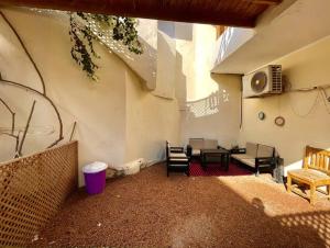 a patio with a table and chairs in a building at BohemiaHouse - Duplex By the sea in Dahab