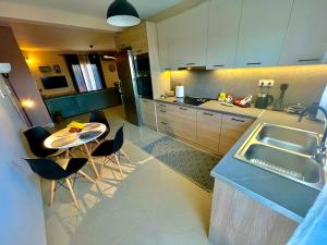 a kitchen with a table and chairs and a sink at Aliki's House in Kalabaka