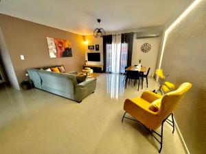 a living room with a couch and chairs and a table at Aliki's House in Kalabaka