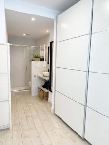 La salle de bains est pourvue d'un mur blanc et d'un miroir. dans l'établissement Nuevo Apto D Centrico Terraza Garaje Incluido, à Castro Urdiales