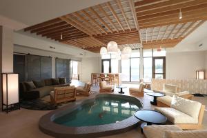 a living room with a large pool in the middle of it at Cedartree Hotel Portland Hillsboro in Hillsboro