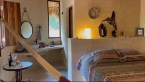 a bathroom with a bed and a sink and a tub at Cabañas HUNAB KU 21 