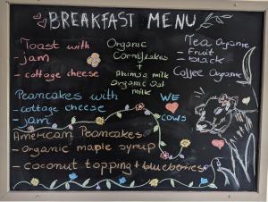 a chalkboard with a sign with a cow on it at The Willoughby in Little Bytham