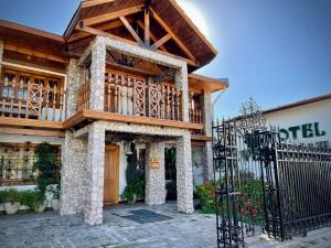 a house with a balcony on top of it at Hotel Boutique Vendimia Premium in Santa Cruz