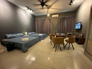 una camera con due letti, un tavolo e una televisione di Vertex Studio Wi-Fi & Netflix a Cyberjaya