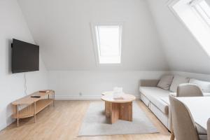 a white living room with a couch and a table at Centrum Condo with Terrace in Bergen