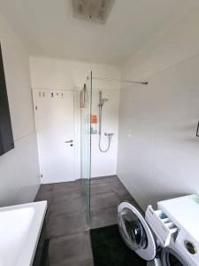 a bathroom with a shower and a toilet and a sink at Michael's City Retreat in Graz