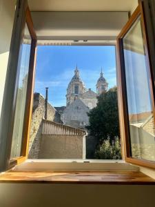an open window with a view of a building at Appartement au coeur de la Ville Fortifiée in Boulogne-sur-Mer +12 photos