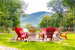 a group of chairs sitting around a table in the grass at Large, Luxury, Views, Near Whiteface, Lake Placid in Wilmington