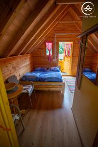 a bedroom with a bed in a log cabin at Rafting Center "TARA-RAFT" in Bastasi