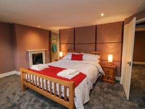 a bedroom with a large bed and a fireplace at The Old Bakehouse in Marlborough