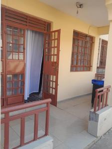 a room with two doors and a bench next to a building at REHOBOTH'S APARTMENTS in Kisumu