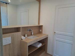 a bathroom with a sink and a mirror at Hôtel Lucien in Paris