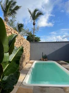 a swimming pool in the backyard of a house at Gostoso Maresia Flats in São Miguel do Gostoso