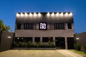 a building with a sign on the side of it at Daho Hotel in Natal