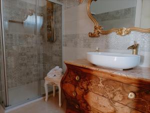 a bathroom with a sink and a glass shower at Savoia23 - Luxury Superior Suite - in Nardò