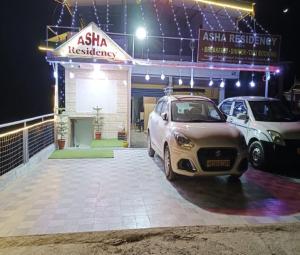 a car dealership with two cars parked in front at Asha Residency by StayApart in Shimla