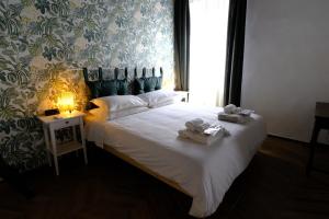 a bedroom with a large white bed with a window at Trevi Little Palace #4 in Rome