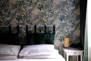 a bedroom with a bed with a floral wallpaper at Trevi Little Palace #4 in Rome
