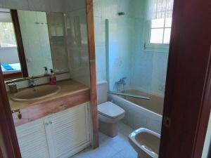a bathroom with a sink and a toilet and a bath tub at Villa Max in Lloret de Mar