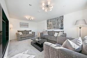 a living room with two couches and a table at Fern Place Villa - Grampian Lettings Ltd 