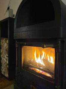 a stove with a fire inside of it at Mountain Getaway Sedrun in Rueras