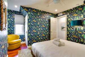 a bedroom with a bed and a yellow chair at Chic Philadelphia Townhome in University City! in Philadelphia