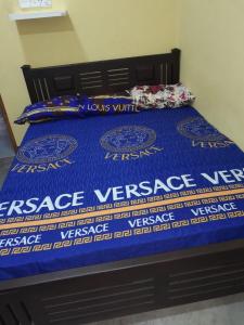 a bed with a blue comforter and pillows on it at MSV VILLA RÉSIDENCE HOME in Batticaloa