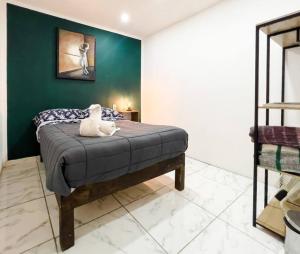 a bedroom with a bed with a stuffed animal on it at Cozy Apartment 10 min from downtown in San Luis Potosí