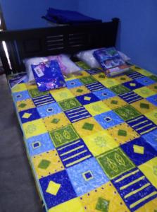 a table with a colorful quilt on top of it at MSV VILLA RÉSIDENCE HOME in Batticaloa