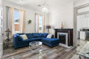 a living room with a blue couch and a fireplace at Spacious Mid City 1BD On The Canal Streetcar Line in New Orleans