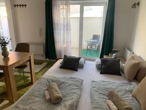 a large bed in a living room with a table at Infinity Apartman in Esztergom