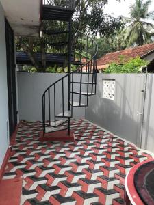 a staircase on a patio with a checkered floor at MSV VILLA RÉSIDENCE HOME in Batticaloa