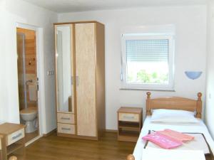 a bedroom with a bed and a sink and a mirror at Pansion Pero Elez Medjugorje in Međugorje
