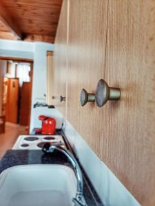 a kitchen with a sink and a wooden cabinet at Panthea Cottage in Stavroupoli