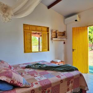 a bedroom with a bed and a window at Sítio SPA Céu De Verdade , Praia de Barra Nova , Ceará in Cascavel +35 photos