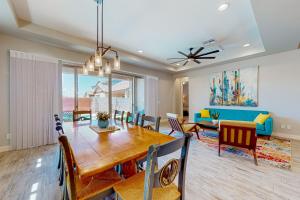 a dining room and living room with a table and chairs at Desert Diamond in Gilbert