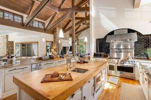 a large kitchen with white cabinets and wooden ceilings at Chateau at Elk Spring in Edwards