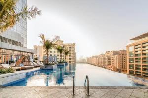 a pool in the middle of a city with buildings at ORION in Dubai
