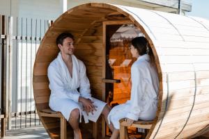 a man and a woman sitting in a sauna at Cuyama Buckhorn in New Cuyama