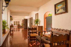 a restaurant with chairs and a table in a room at Villas Arqueologicas Chichen Itza in Chichén-Itzá