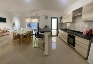 a kitchen with a table and a dining room at La Palmerita in Villa Carlos Paz