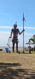 a metal sculpture of a crab on the beach at El Pericon y Belgrano in Punta Indio
