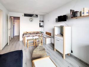 a small room with a table and a refrigerator at Studio fonctionnel au pied des pistes - FR-1-267-232 in Villarembert