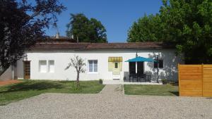 een wit huis met een blauw dak bij Maison pour 4/ 6 personnes les hirondelles in Saint-Vivien-de-Monségur