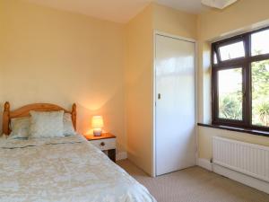 a bedroom with a bed and a window at Hideaway in Alfreton