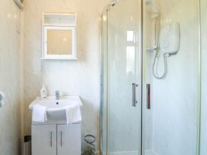 a bathroom with a shower and a sink at Hideaway in Alfreton
